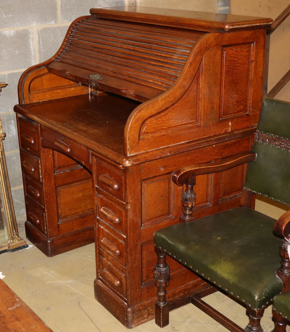 An early 20th century oak roll top desk with S shaped tambour, W.106cm, D.76cm, H.125cm